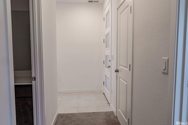 hallway with light tile patterned flooring