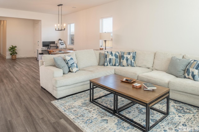 living room with hardwood / wood-style floors and a notable chandelier