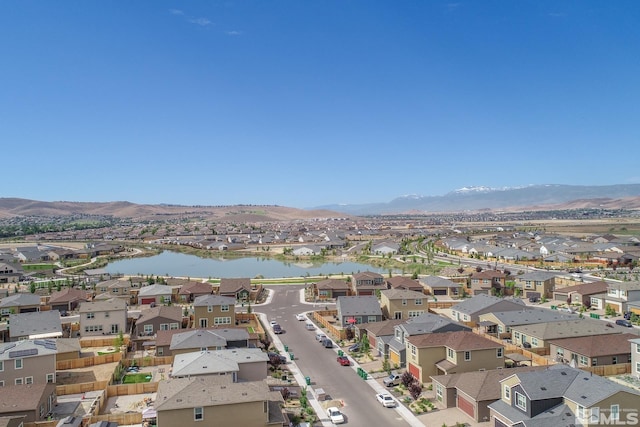 birds eye view of property featuring a water and mountain view