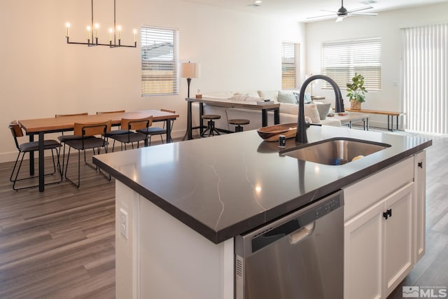 kitchen featuring sink, hanging light fixtures, stainless steel dishwasher, a kitchen island with sink, and white cabinets