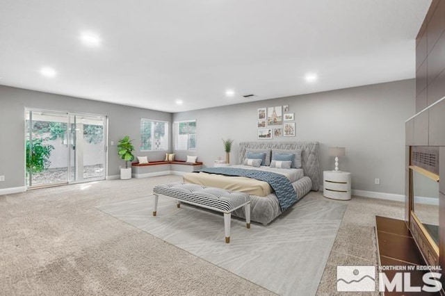 bedroom featuring baseboards, light carpet, and access to outside