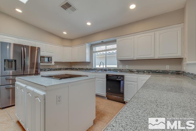 kitchen featuring white cabinetry, a kitchen island, visible vents, and stainless steel appliances