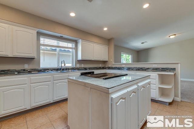 kitchen featuring white cabinetry, light tile patterned flooring, and a kitchen island