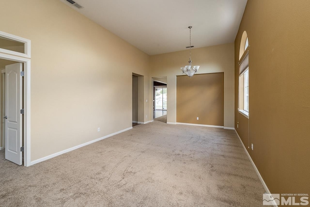 unfurnished room featuring carpet, a notable chandelier, and a towering ceiling