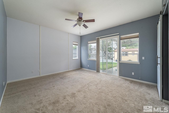 carpeted empty room with ceiling fan