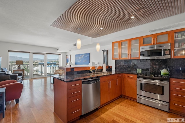 kitchen featuring kitchen peninsula, hanging light fixtures, sink, wood ceiling, and stainless steel appliances