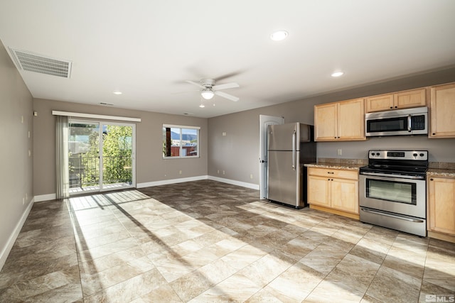 kitchen with appliances with stainless steel finishes, light brown cabinets, and ceiling fan