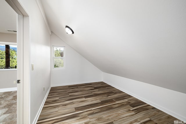 bathroom with a healthy amount of sunlight, toilet, and tiled shower / bath