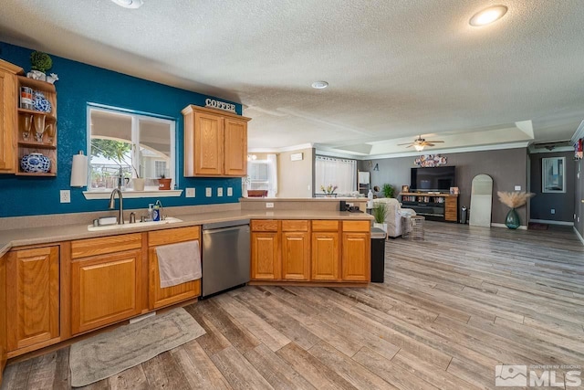 kitchen with dishwasher, sink, light hardwood / wood-style flooring, ceiling fan, and a textured ceiling