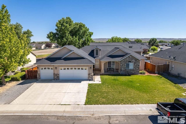 view of front of house with a garage and a front lawn