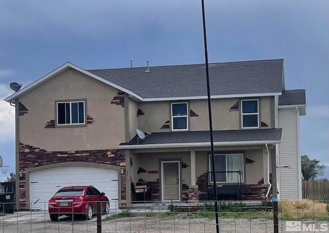 view of front of house featuring a porch and a garage