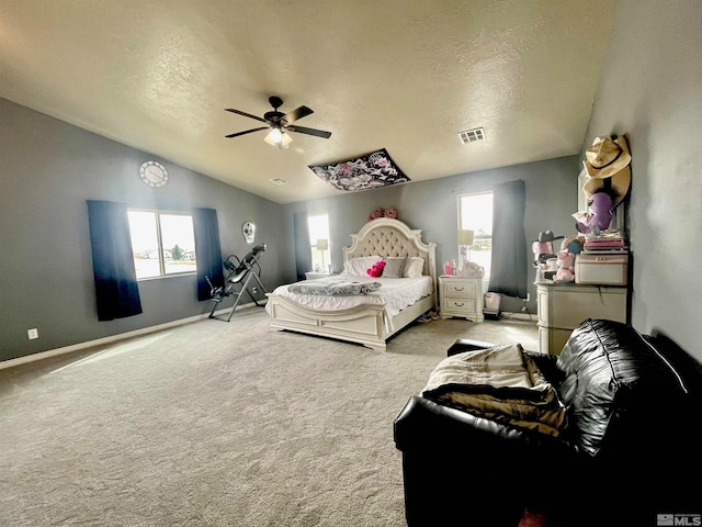 carpeted bedroom featuring ceiling fan, vaulted ceiling, and a textured ceiling