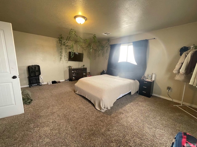 bedroom with a textured ceiling and carpet