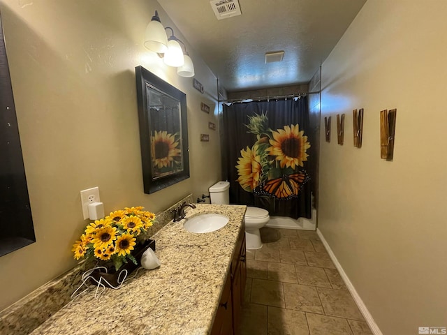 bathroom featuring tile flooring, oversized vanity, and toilet