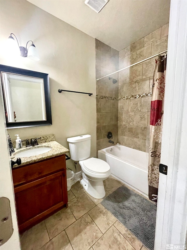 full bathroom with tile flooring, shower / bath combo, a textured ceiling, toilet, and vanity