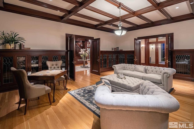 living room with light wood-type flooring, coffered ceiling, and beamed ceiling