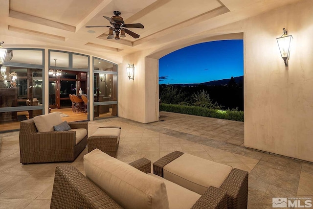 patio terrace at dusk with ceiling fan and outdoor lounge area