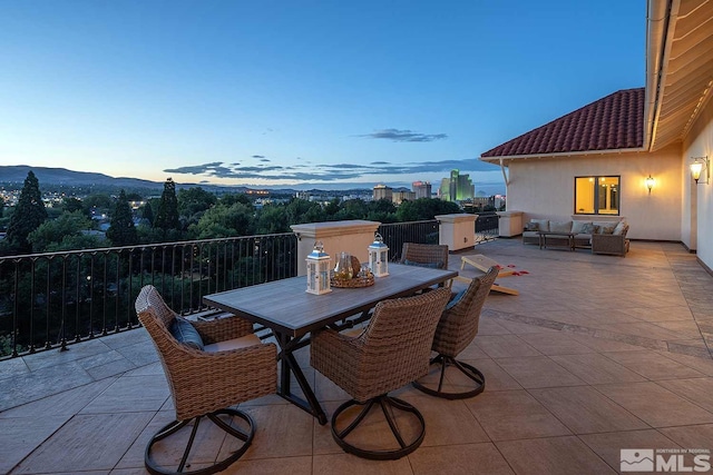view of patio / terrace with outdoor lounge area, outdoor dining area, and a mountain view