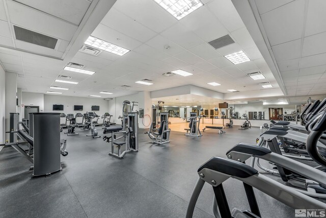 exercise room featuring a drop ceiling