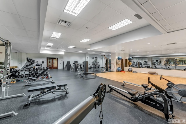 gym with a paneled ceiling