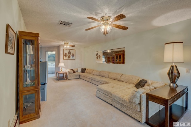 carpeted living room with a textured ceiling and ceiling fan