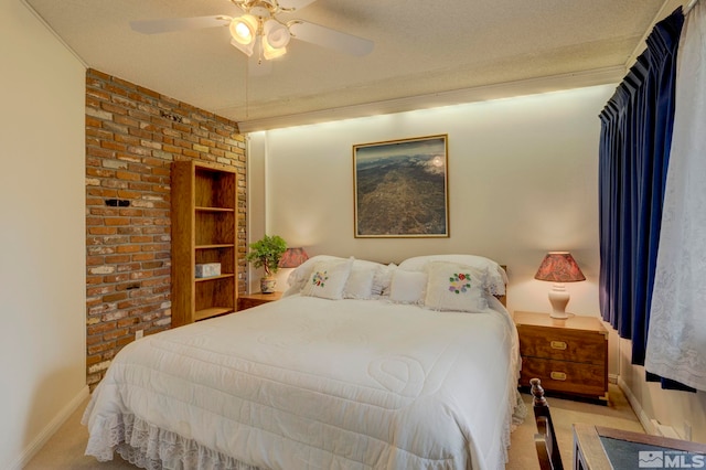 bedroom featuring ceiling fan, light colored carpet, a textured ceiling, and brick wall