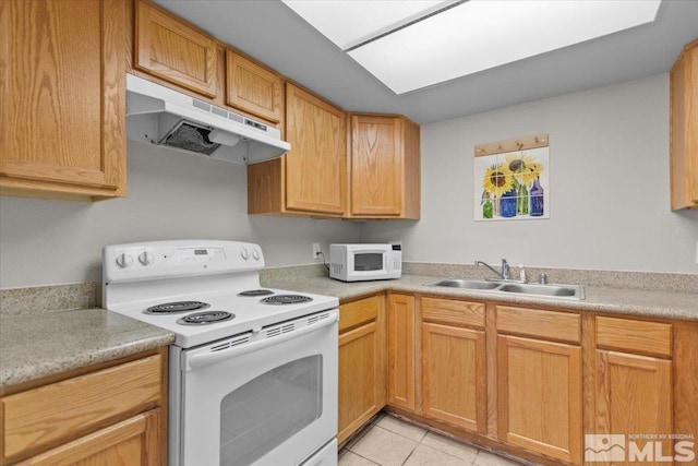 kitchen with sink, light tile patterned floors, and white appliances