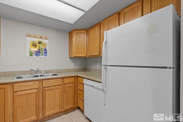 kitchen with sink, light tile patterned flooring, and white appliances