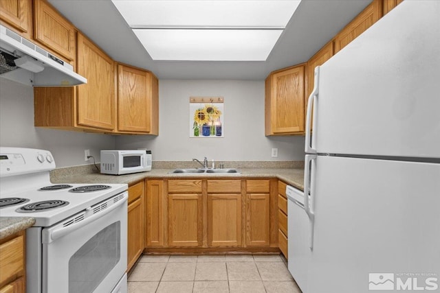 kitchen with light tile patterned flooring, white appliances, and sink