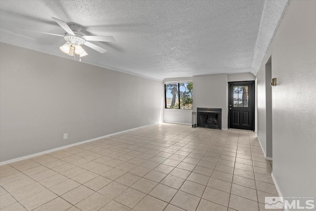 unfurnished living room featuring ceiling fan and light tile patterned floors