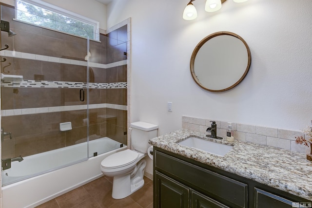 full bathroom featuring decorative backsplash, tile patterned floors, vanity, enclosed tub / shower combo, and toilet