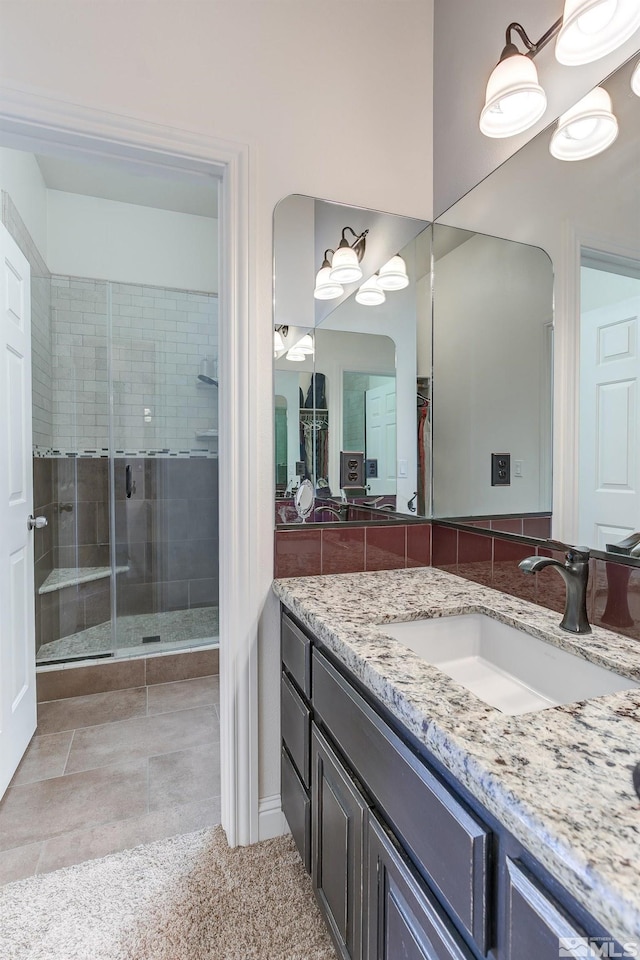 bathroom featuring vanity and an enclosed shower