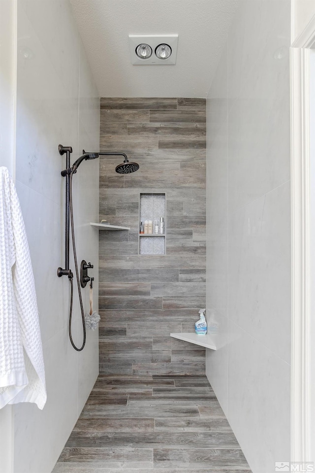 bathroom with a tile shower