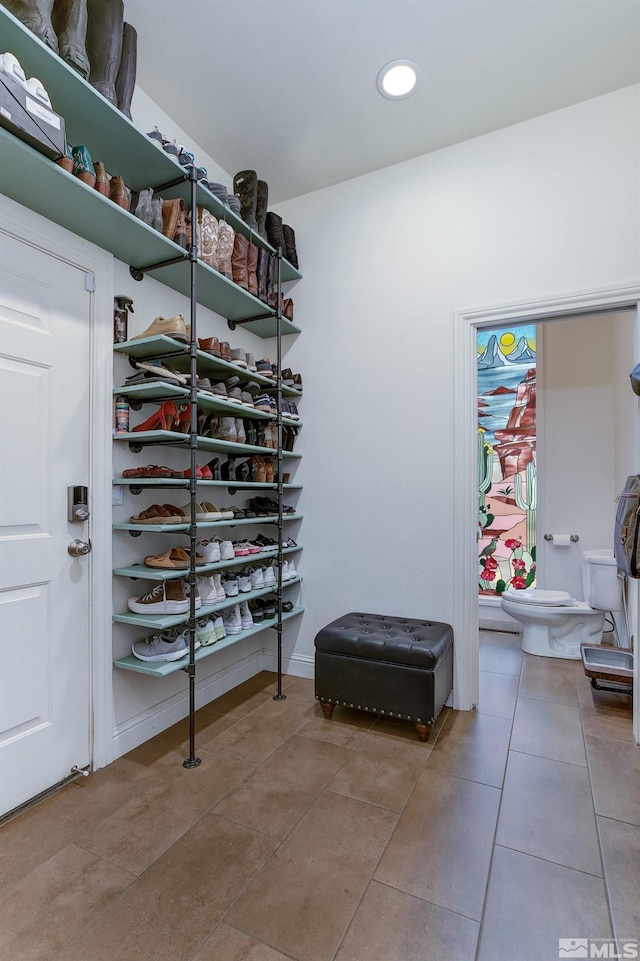 spacious closet featuring tile patterned flooring