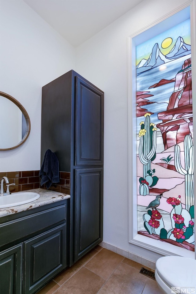 bathroom with tile patterned floors, vanity, and toilet