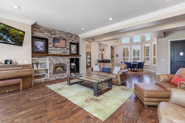 living room featuring hardwood / wood-style floors, a fireplace, and crown molding