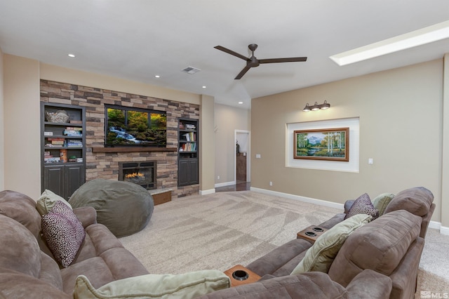 carpeted living room featuring a fireplace, built in features, and ceiling fan