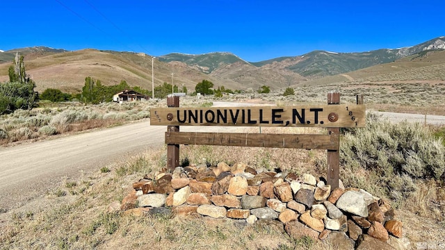 community sign with a mountain view