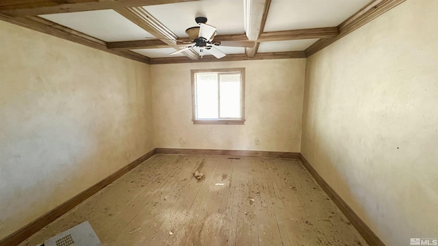 spare room with beam ceiling, ceiling fan, coffered ceiling, crown molding, and hardwood / wood-style floors