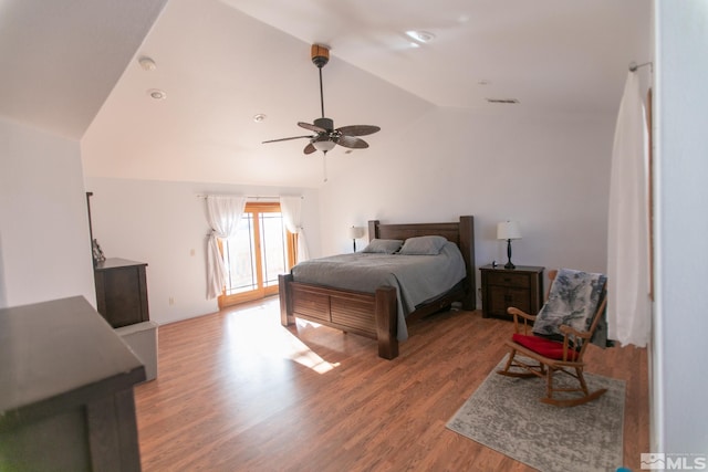 bedroom with lofted ceiling, hardwood / wood-style flooring, and ceiling fan