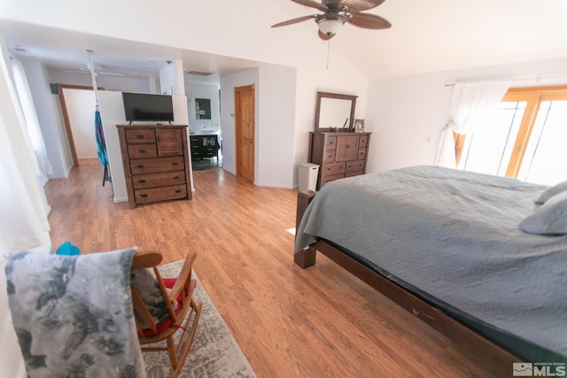 bedroom with lofted ceiling, ceiling fan, and light hardwood / wood-style flooring