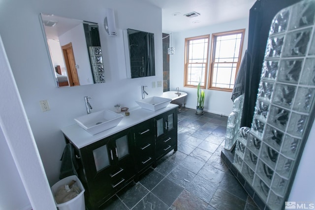 bathroom with a washtub and vanity