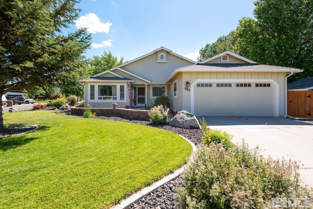 ranch-style house featuring a garage and a front yard