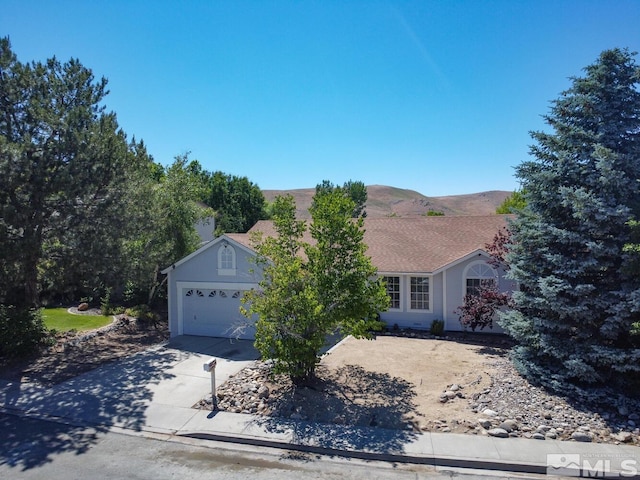 ranch-style home featuring a mountain view and a garage