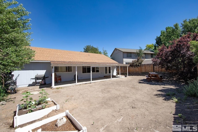 rear view of property featuring a patio area