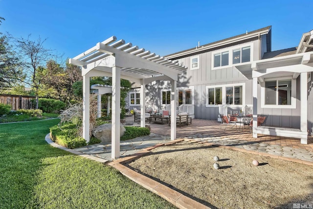 rear view of property featuring outdoor lounge area, a yard, a pergola, and a patio area