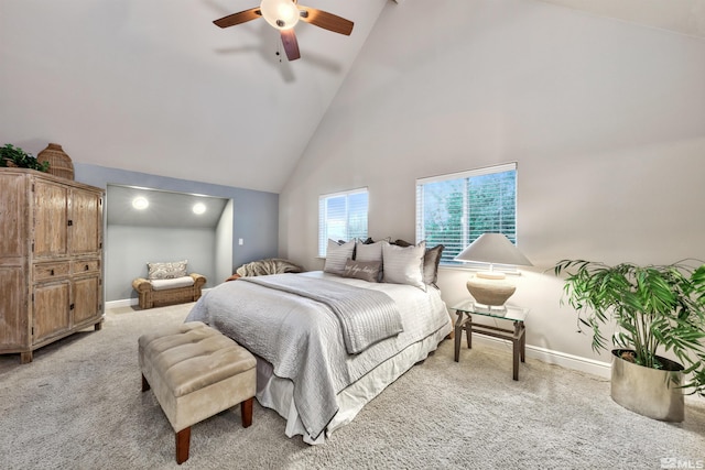 carpeted bedroom featuring ceiling fan and high vaulted ceiling