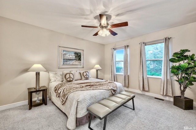 bedroom with ceiling fan and light carpet