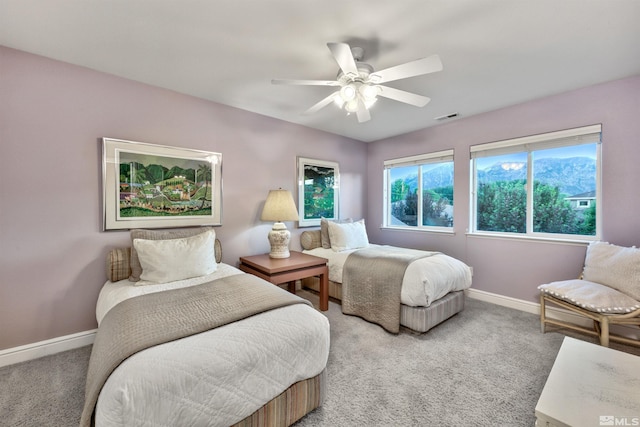 bedroom featuring ceiling fan and carpet