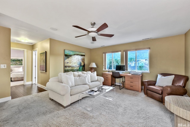 living room with ceiling fan and wood-type flooring